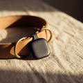 Pawse Tracker minimalist matte black GPS tag on leather collar with brass D-ring